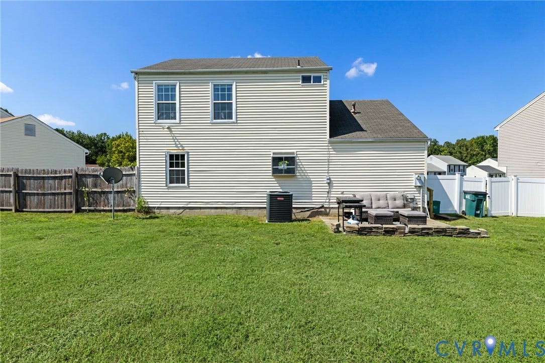 4429 Crown Squire Road, Henrico, VA 23231 Expansive backyard featuring a concrete patio with stone retaining wall