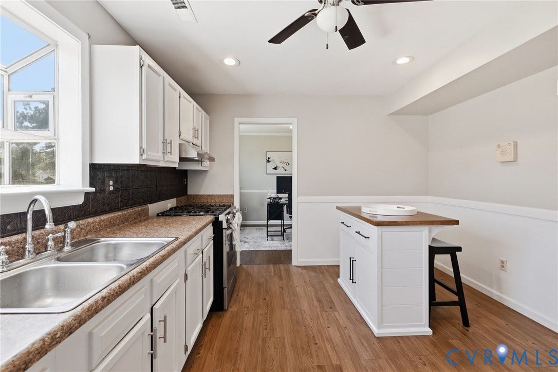 4429 Crown Squire Road, Henrico, VA 23231 Kitchen featuring white cabinetry, a double basin stainless steel sink, a gas range, wood-finish flooring, and a ceiling fan with integrated lighting