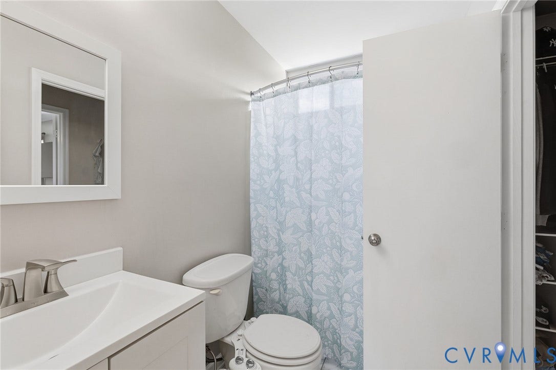4429 Crown Squire Road, Henrico, VA 23231 White vanity with integrated sink, brushed nickel faucet, framed wall mirror, and privacy frosted glass window