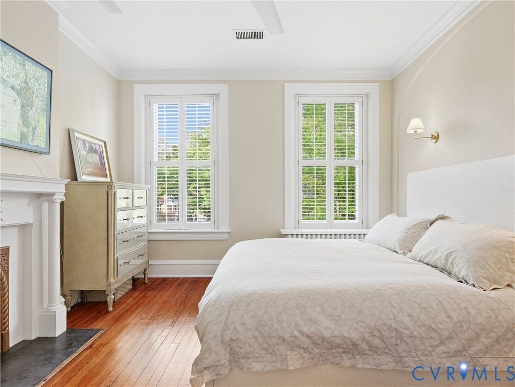 1829 Floyd Avenue, The Fan, Richmond, VA 23220 Hardwood flooring, crown molding, double windows with plantation shutters, wall-mounted sconce, and fireplace with mantel