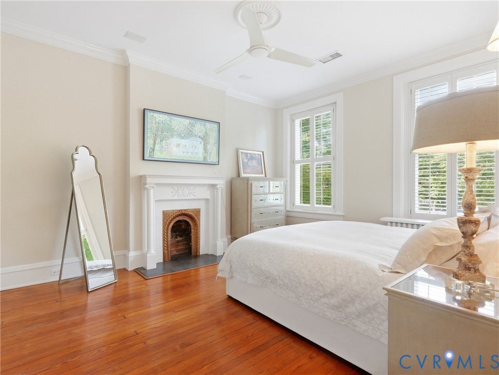 1829 Floyd Avenue, The Fan, Richmond, VA 23220 Hardwood flooring, fireplace with decorative mantel, crown molding, ceiling fan, and multiple windows with plantation shutters
