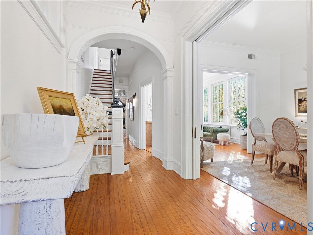 1829 Floyd Avenue, The Fan, Richmond, VA 23220 Polished wood-finish flooring, white painted walls, arched entryway, staircase with white newel posts, and interior French doors