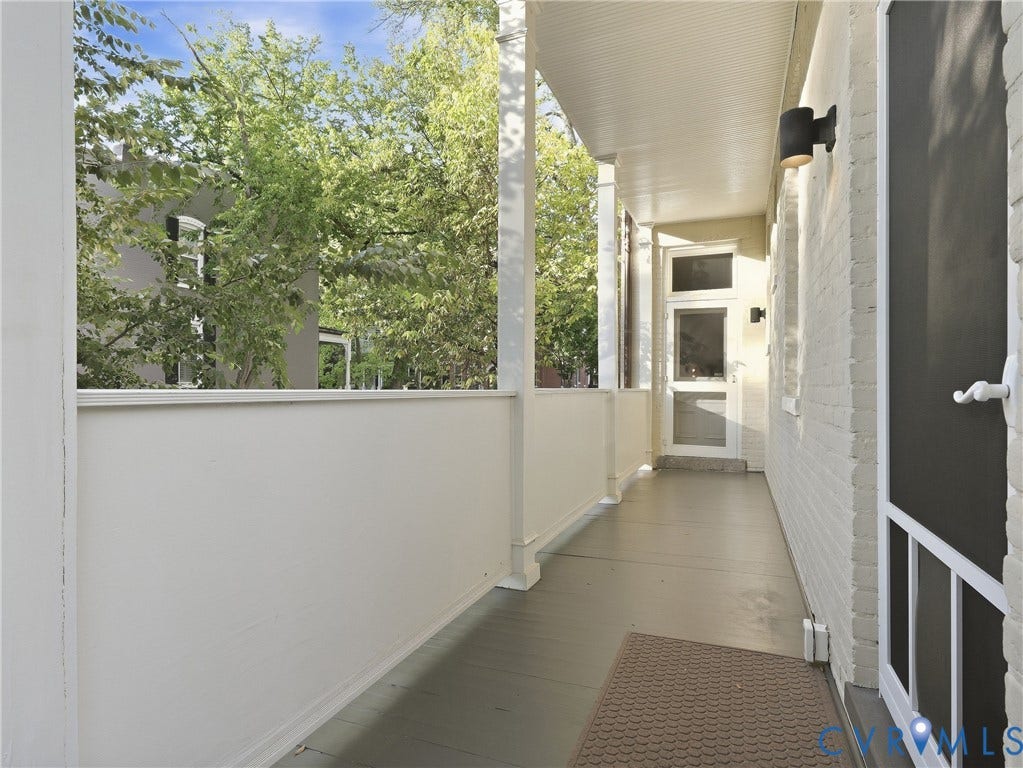 1829 Floyd Avenue, The Fan, Richmond, VA 23220 Expansive covered porch featuring painted wood flooring, white painted brick exterior, and a screen door entry