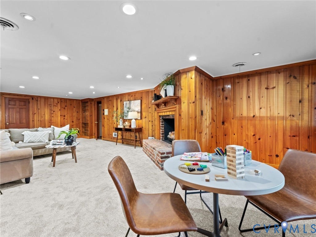 3436 Kenmore Road, Richmond, VA 23225 Recessed lighting, wood paneling, brick fireplace with wood mantel, and light-toned carpeting