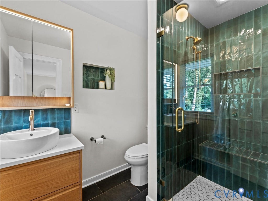 3436 Kenmore Road, Richmond, VA 23225 Glass-enclosed shower with a built-in bench, green subway tile, and a hexagon tile floor