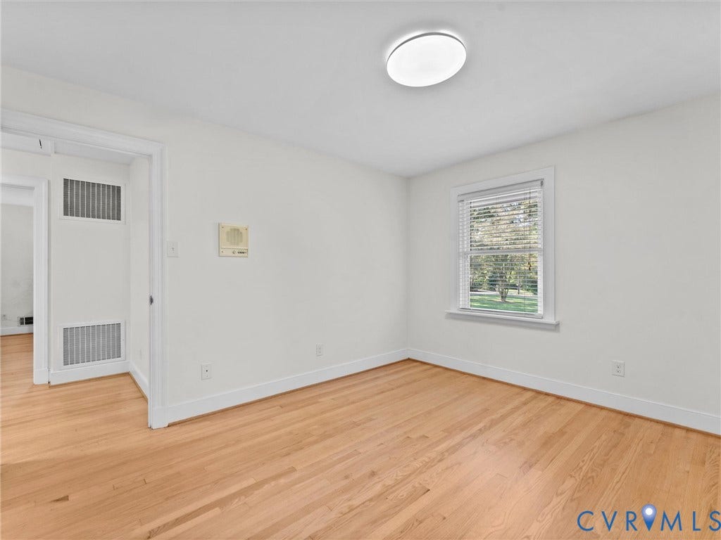 3436 Kenmore Road, Richmond, VA 23225 Hardwood flooring, white painted walls, window with blinds, and flush mount ceiling light