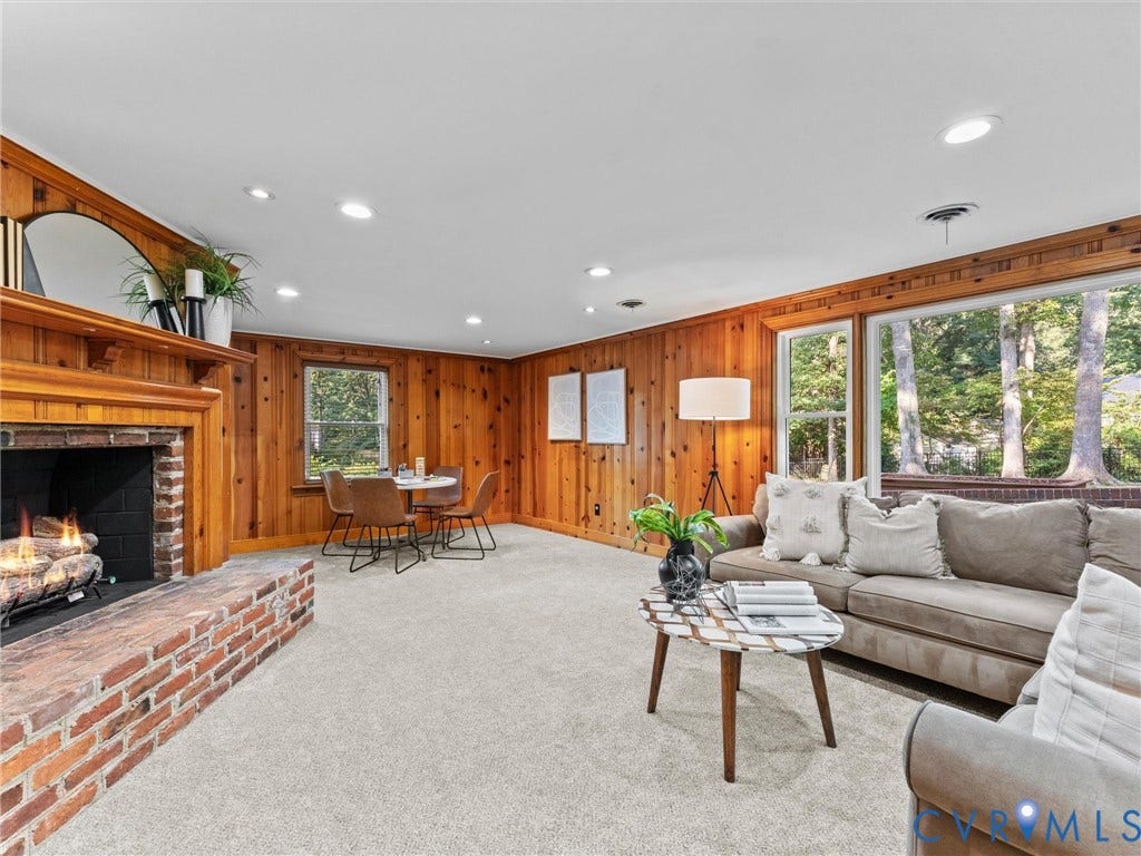 3436 Kenmore Road, Richmond, VA 23225 Wood paneling throughout, brick fireplace with a wood mantle, recessed lighting, carpet flooring, and large windows with natural light