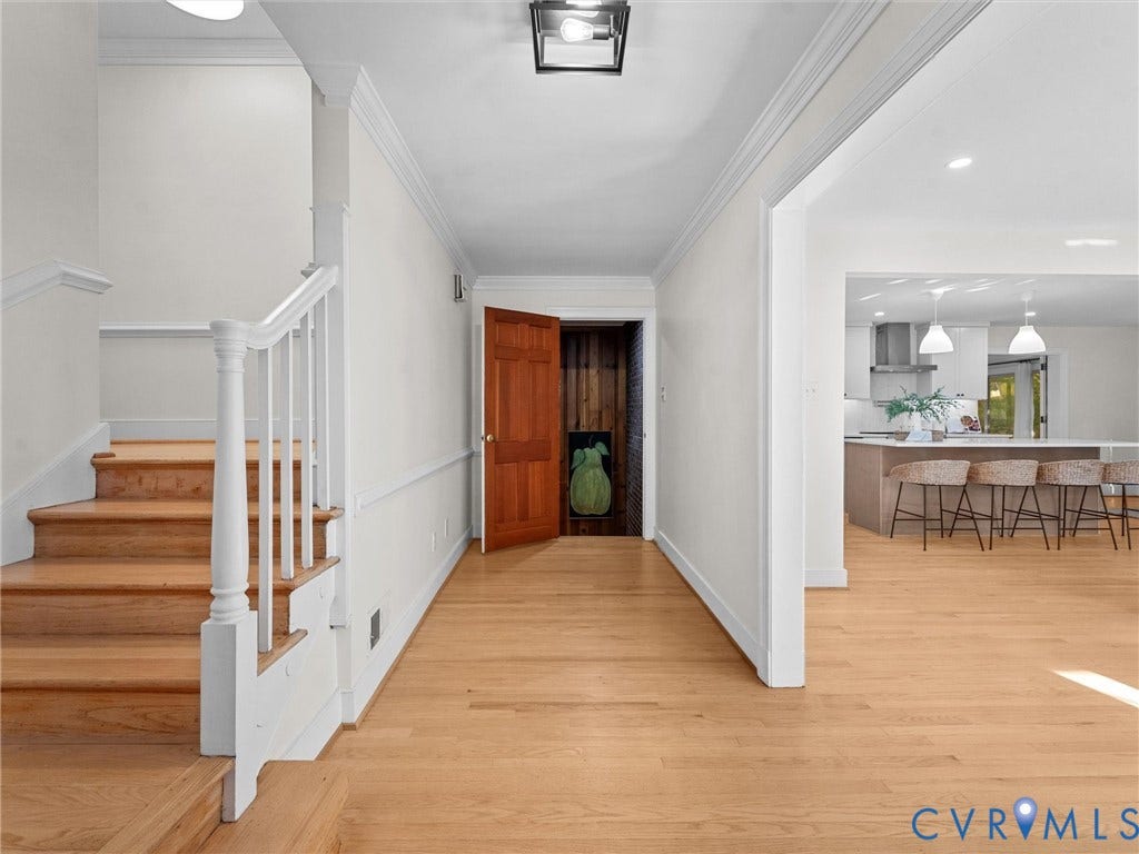 3436 Kenmore Road, Richmond, VA 23225 Hardwood flooring extending throughout, staircase with white newel post and balusters, crown molding detailing, recessed lighting, and kitchen with pendant lighting
