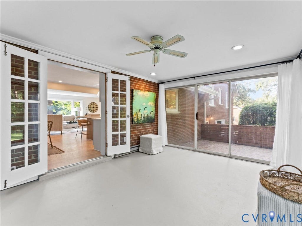 3436 Kenmore Road, Richmond, VA 23225 Recessed lighting, ceiling fan, brick accent wall, white french doors, and sliding glass doors to a patio