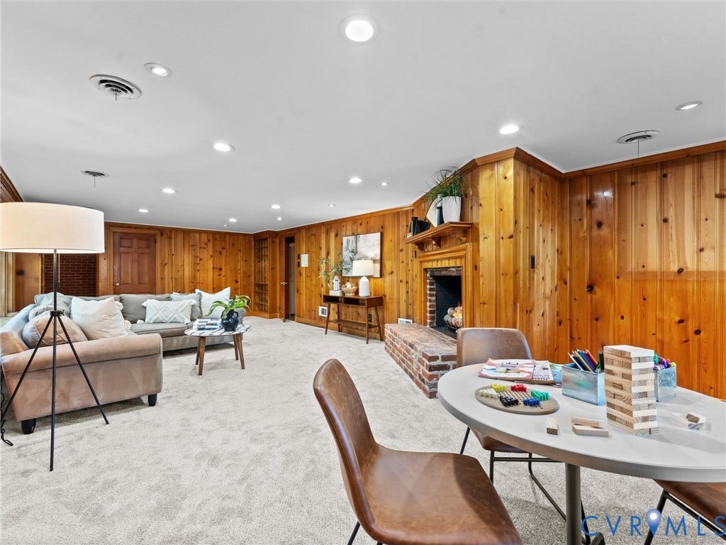 3436 Kenmore Road, Richmond, VA 23225 Wood-paneled walls, brick fireplace with mantel, recessed lighting, and light-colored carpeting