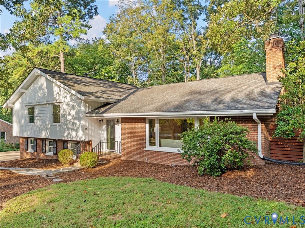 3436 Kenmore Road, Richmond, VA 23225 Brick and white siding exterior with a dark shingle roof and a prominent brick chimney