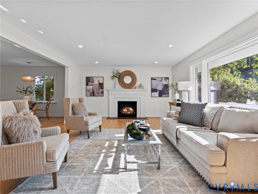 3436 Kenmore Road, Richmond, VA 23225 Spacious living area featuring light wood-finish flooring, a white mantel fireplace, recessed lighting, and large windows