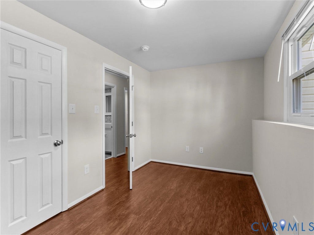 Wood-finish flooring with neutral wall tones and white trim