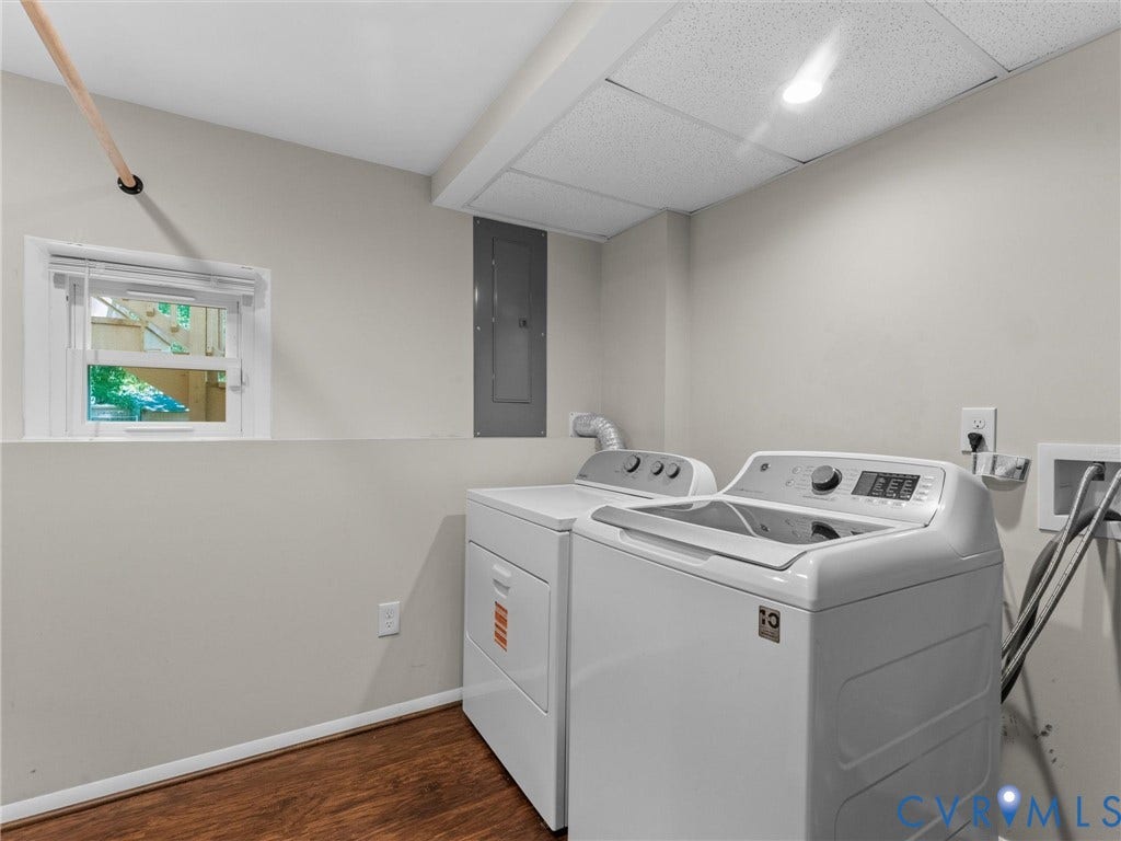 Laundry area featuring wood-finish flooring, a window with blinds, and recessed lighting