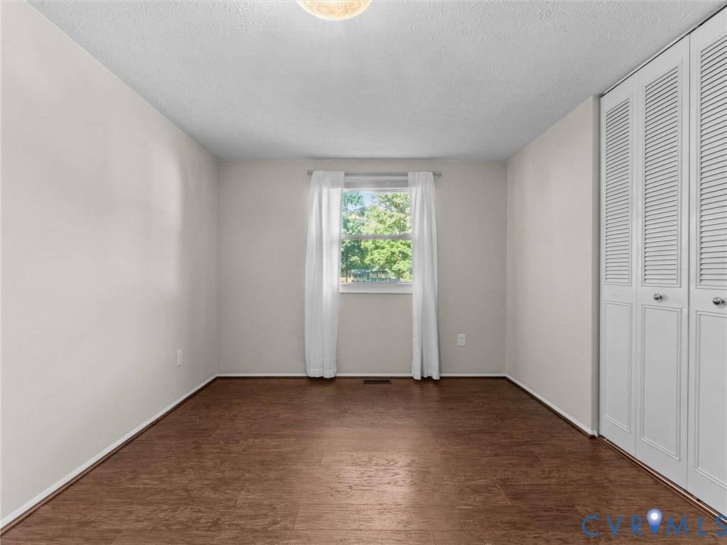 Warm wood-finish flooring with white walls