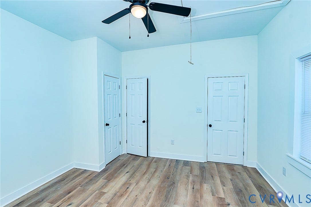 2813 Burfoot Street, Richmond, VA 23224 LVP flooring with white trim, a ceiling fan, and white paneled doors