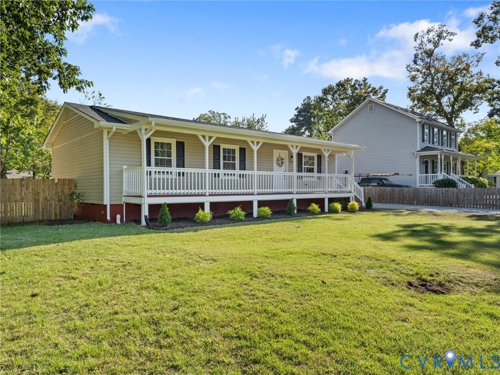 Expansive front lawn with mature trees and landscaping