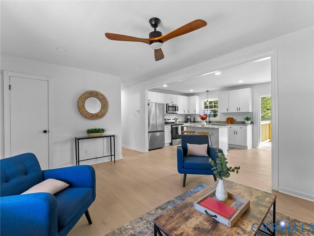 Recessed lighting, wood-finish flooring, and a ceiling fan with wood-finish blades