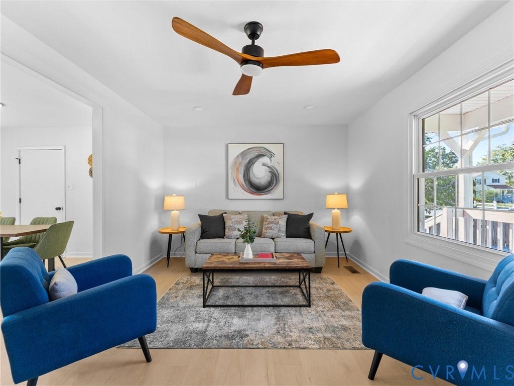 Light wood-finish flooring, recessed lighting, and a modern ceiling fan with wood-finish blades