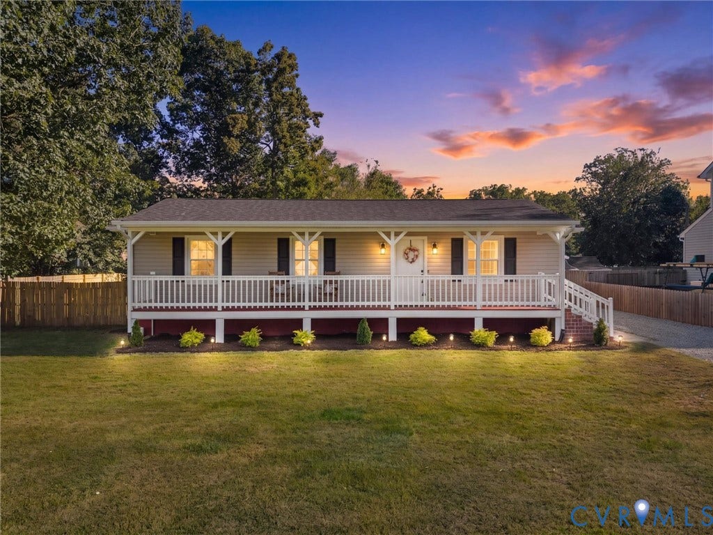 Front exterior with neutral siding, covered porch, and white railings