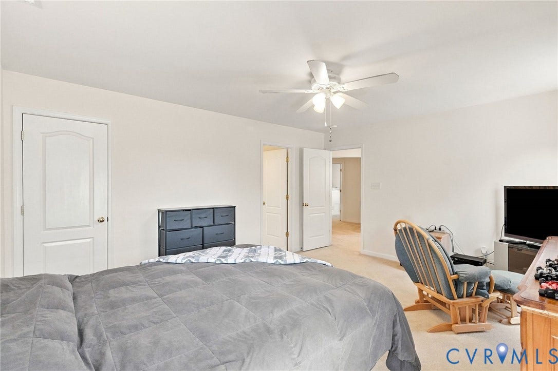 Neutral wall finishes, white trim, and a ceiling fan with integrated lighting