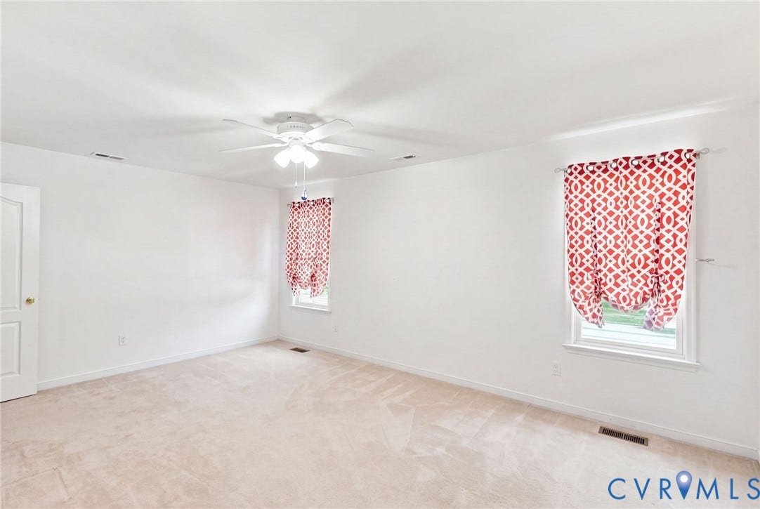 Wall-to-wall carpeting, ceiling fan with integrated lighting, and white trim
