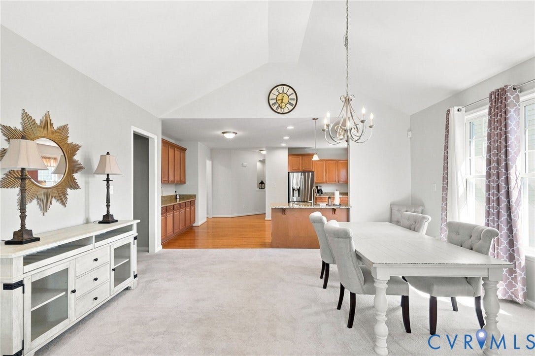 Vaulted ceiling, recessed lighting, chandelier, wood-finish flooring, and light-toned walls