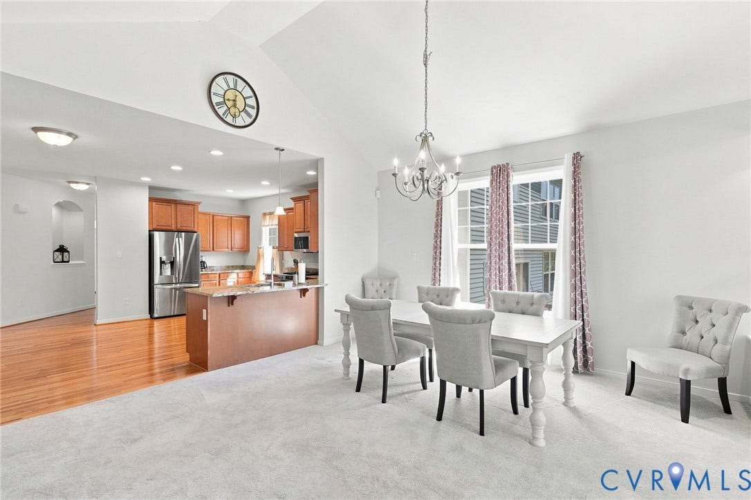 Vaulted ceiling in dining area with chandelier