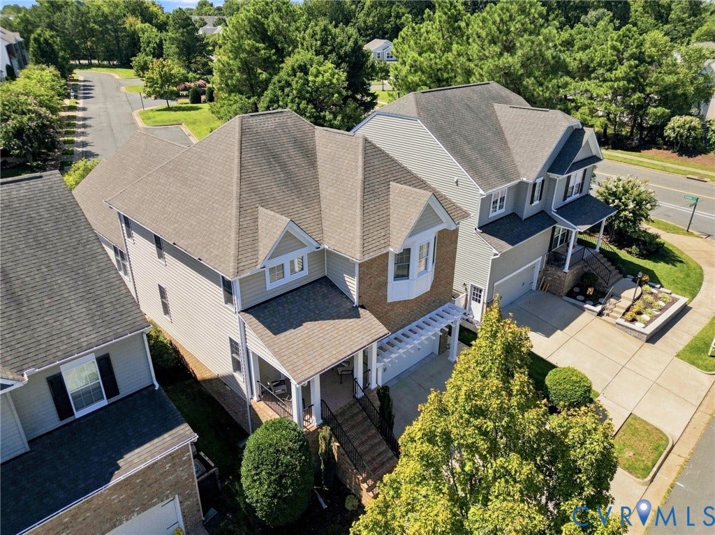 Multilevel roofline featuring dormer windows and a covered entry