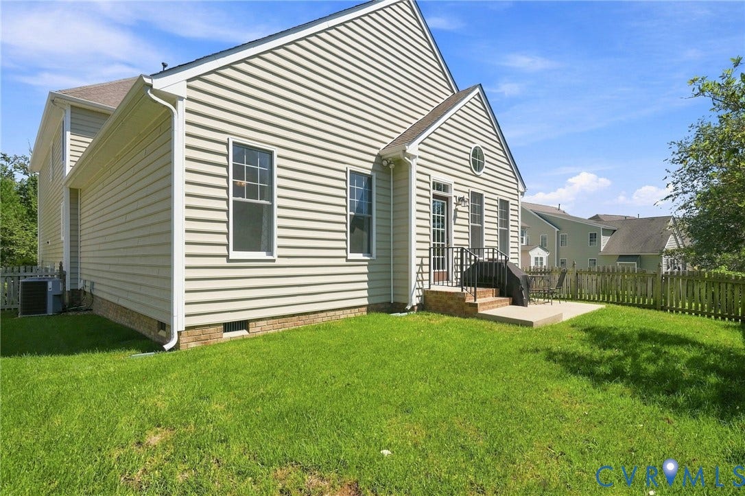 Siding exterior with brick foundation and white trim