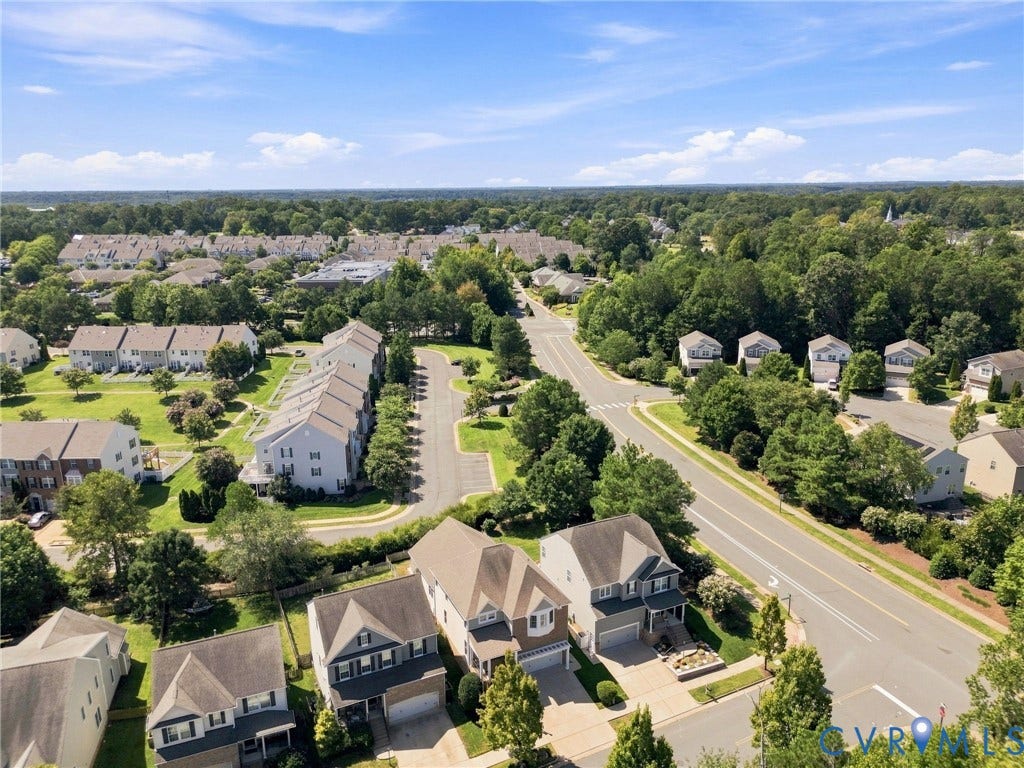 Aerial perspective showcasing residential properties with tree-lined streets and verdant landscaping