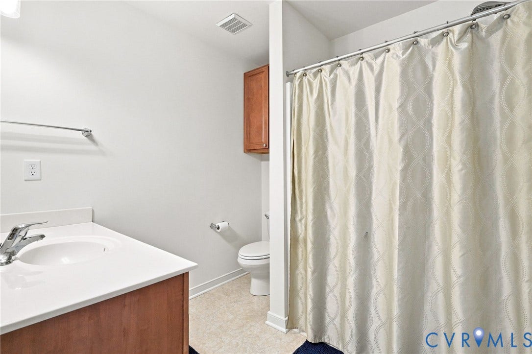White solid surface countertop with an integrated sink and chrome faucet