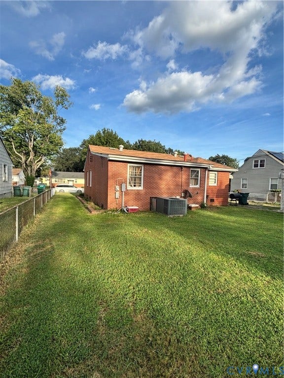 3510 Howard Road, Richmond, VA 23223 Red brick exterior with a brown shingle roof, double-hung windows, and central air conditioning unit