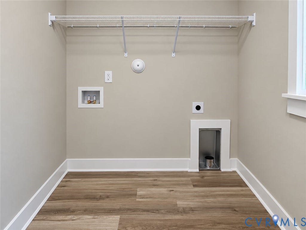 1010 Johnson Road, Mineral, VA 23117 Utility space featuring a wire shelf, wood-finish flooring, and a window