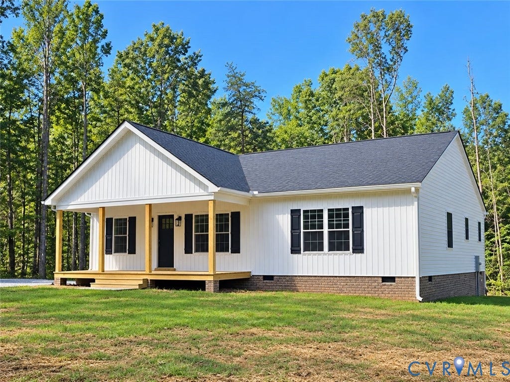 1010 Johnson Road, Mineral, VA 23117 White siding exterior with a dark shingle roof, covered front porch, black front door, and black window shutters