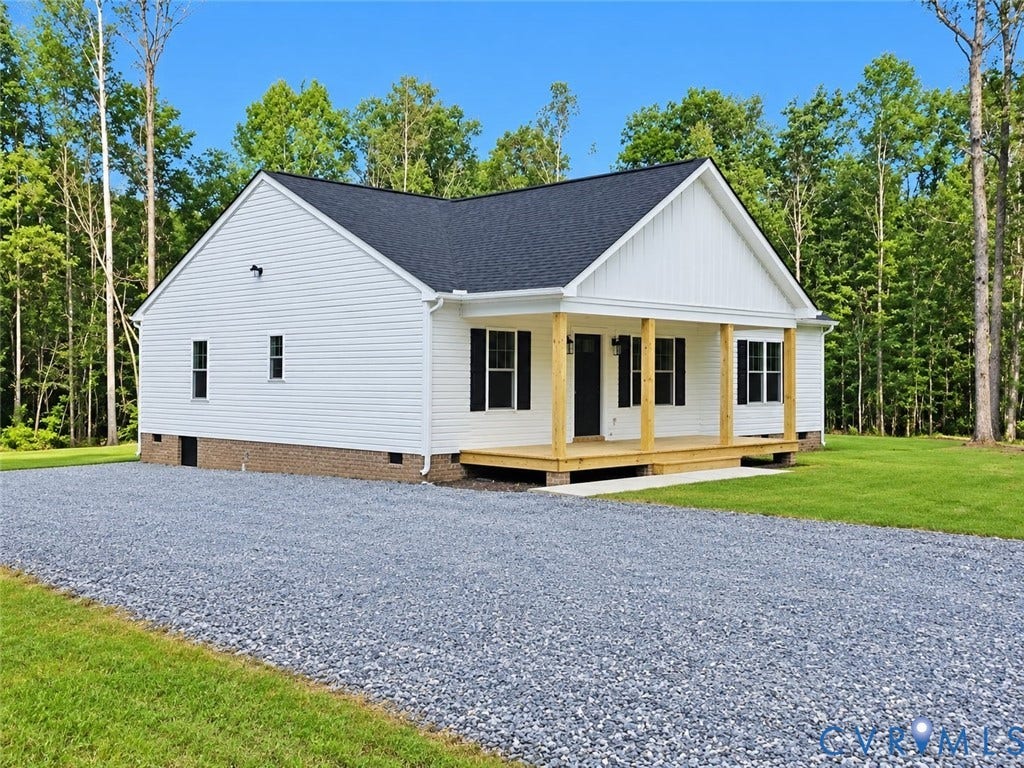 1010 Johnson Road, Mineral, VA 23117 White siding exterior with a dark shingle roof, wood-frame front porch, black window shutters, and a gravel driveway