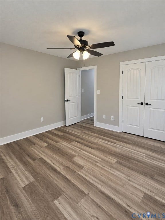 1010 Johnson Road, Mineral, VA 23117 Wood-finish flooring, white paneled doors with black hardware, and a black ceiling fan with integrated lighting