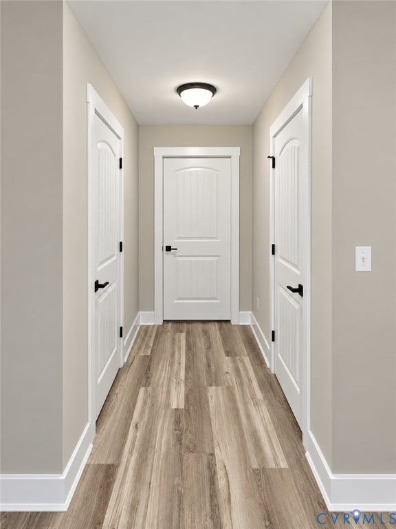 1010 Johnson Road, Mineral, VA 23117 Hallway featuring wood-finish flooring, recessed ceiling light, and white paneled doors with dark hardware
