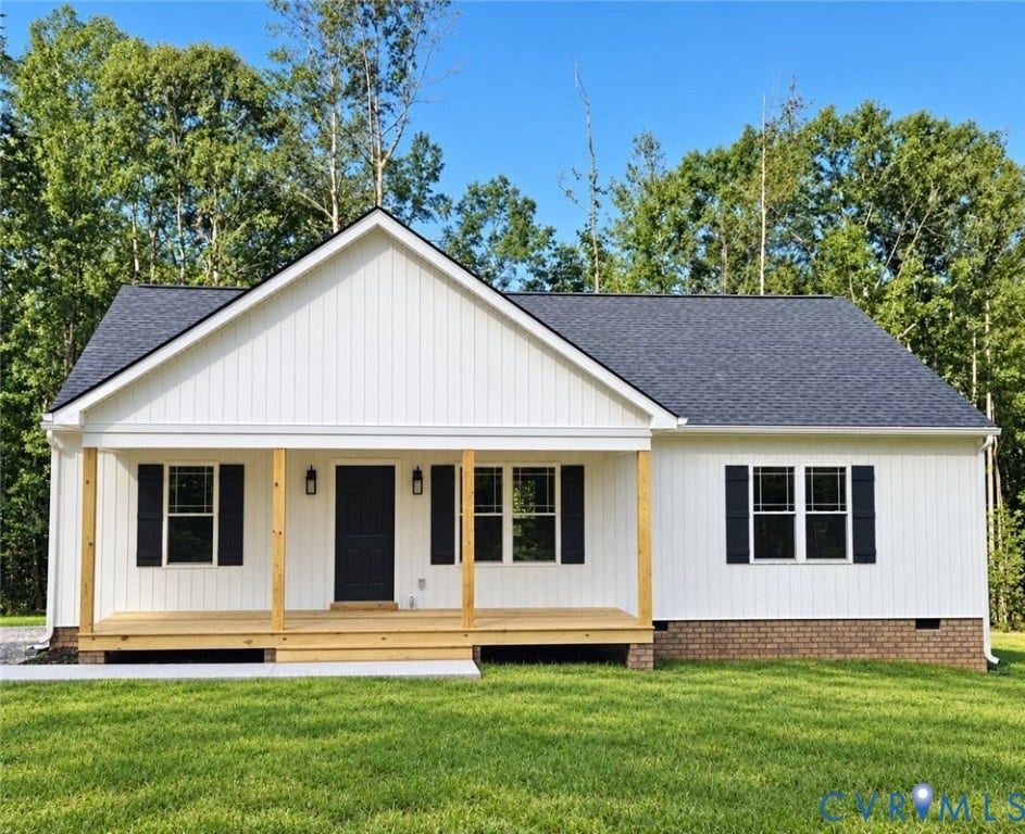 1010 Johnson Road, Mineral, VA 23117 White vertical siding exterior with dark shutters, a covered wooden porch, a dark shingle roof, and brick foundation accents