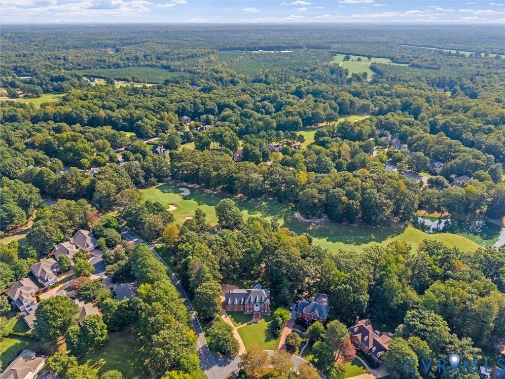 Expansive wooded landscape with residential properties and golf course features