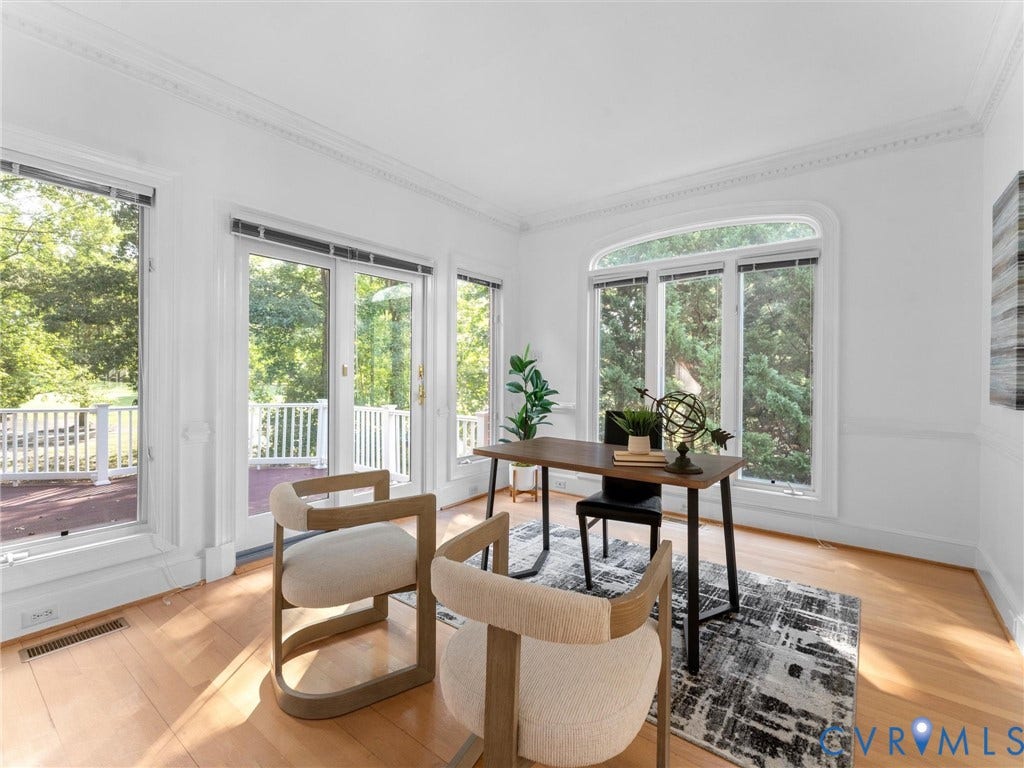 Hardwood flooring throughout, with extensive natural light from multiple windows and glass-paneled doors