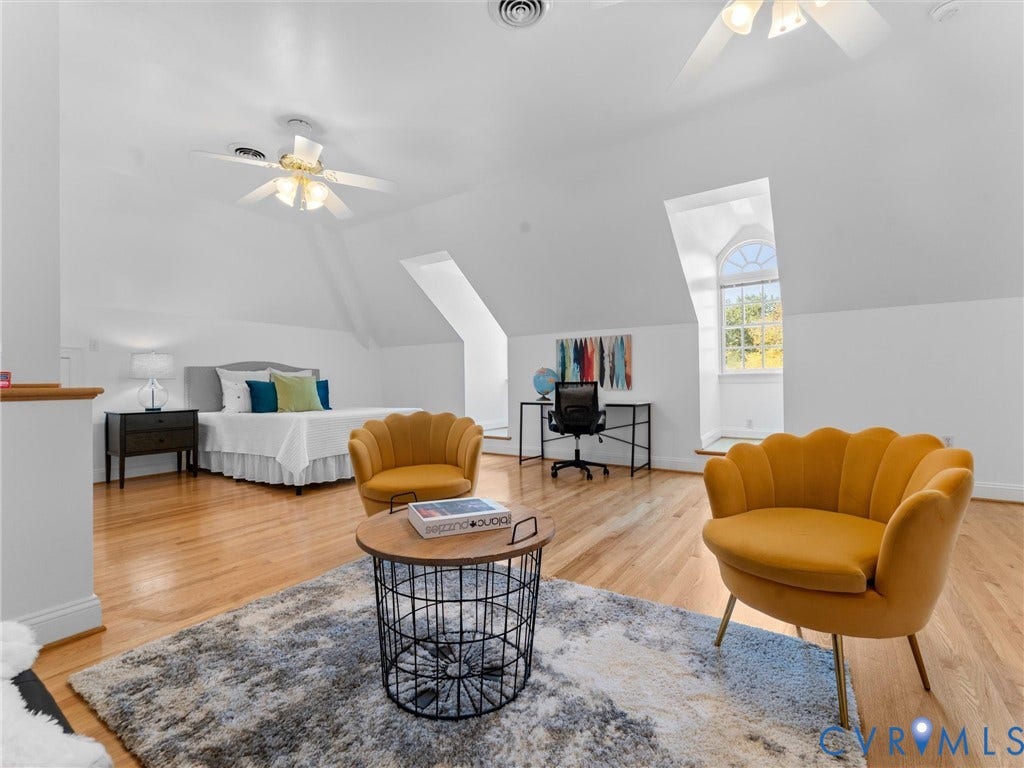 3rd floor, Spacious room with wood-finish flooring, vaulted ceilings, and a half-round window