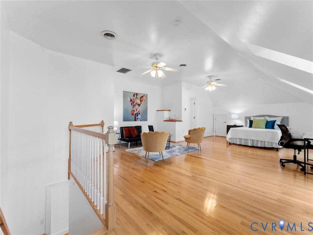 3rd floor, Spacious open-concept room featuring hardwood flooring, sloped ceilings, and white painted walls