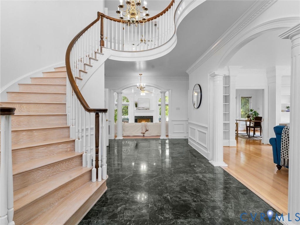 Curved staircase with wood-finish treads and white balusters