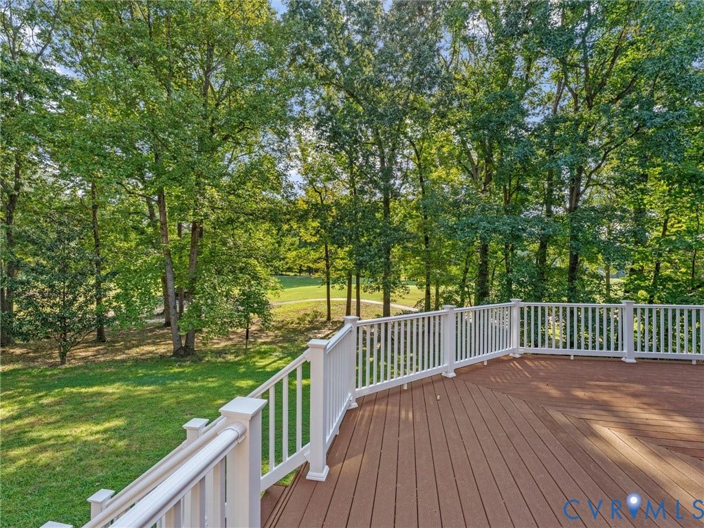 Spacious outdoor deck with a white railing system and wood-finish decking