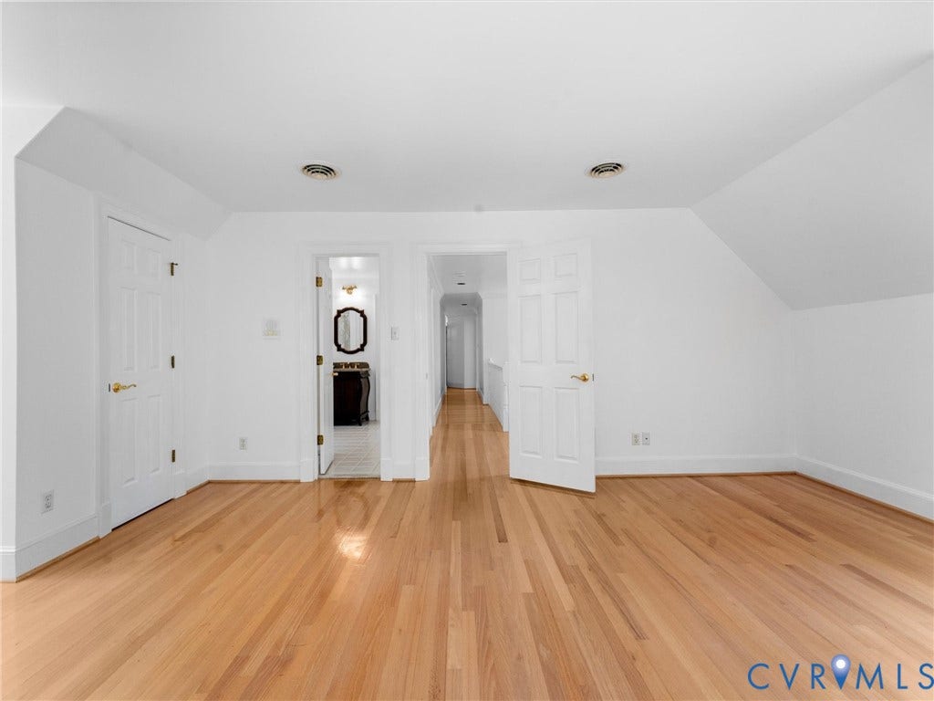Hardwood flooring, painted walls, and white trim