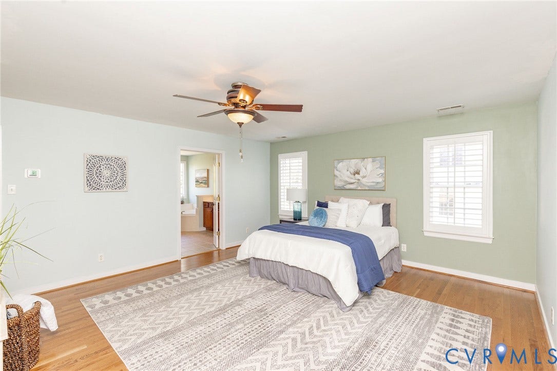 12669 Fawn Lane, Goochland, VA 23233 Hardwood flooring throughout, ceiling fan with integrated lighting, two windows with white plantation shutters, and a doorway opening to an adjacent room
