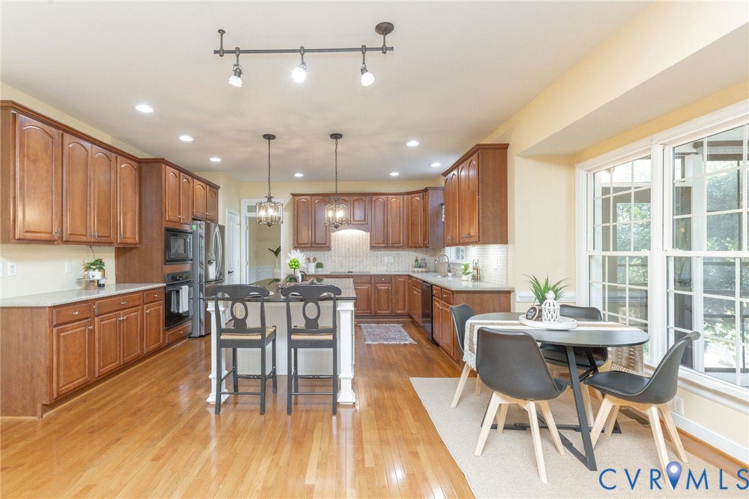 12669 Fawn Lane, Goochland, VA 23233 Full kitchen featuring wood-finish cabinetry, light-toned countertops, and wood-finish flooring