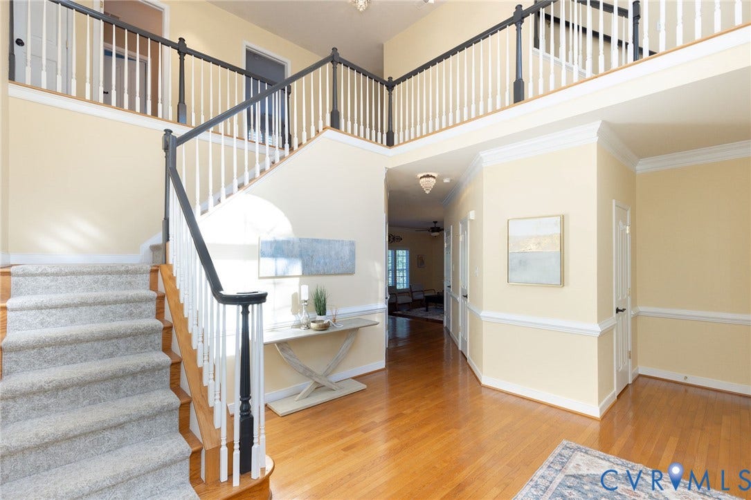 12669 Fawn Lane, Goochland, VA 23233 Two-story foyer featuring hardwood flooring, a carpeted staircase, and a second-level open landing with a railing