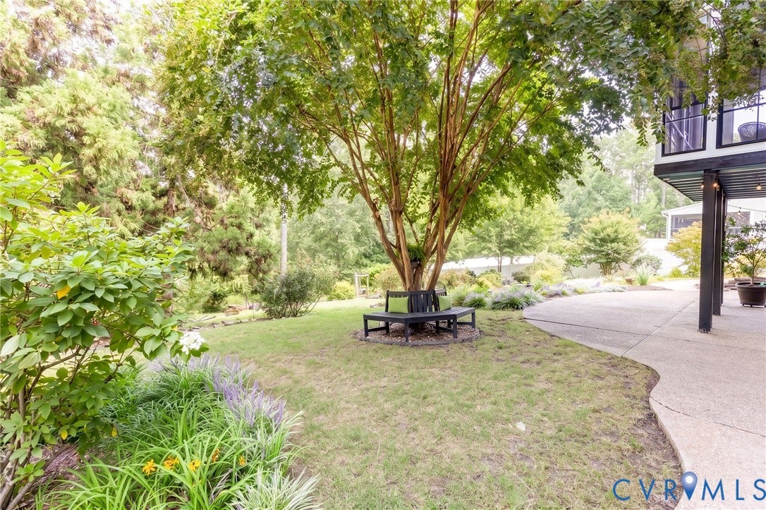 12669 Fawn Lane, Goochland, VA 23233 Expansive exterior space featuring a mature tree, manicured lawn, and a curved concrete patio